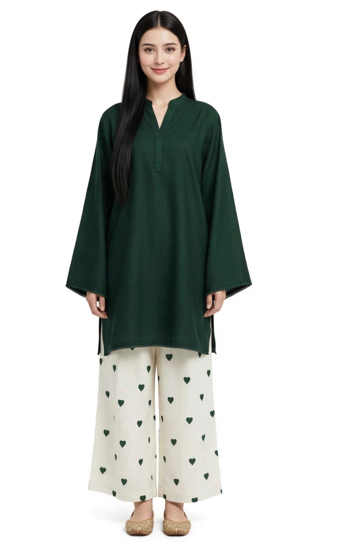 A woman modeling a dark green long-sleeve tunic with a split neckline, paired with off-white wide-leg pants featuring a green heart pattern, against a plain white background.